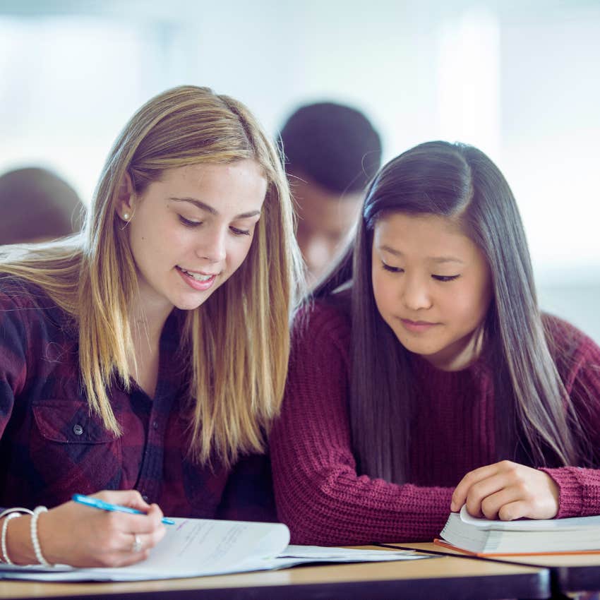 two high school students studying in class together