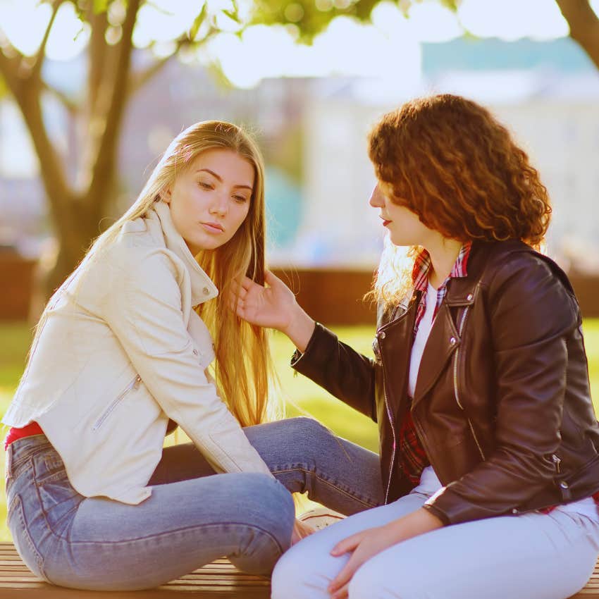 two friends sitting outside together