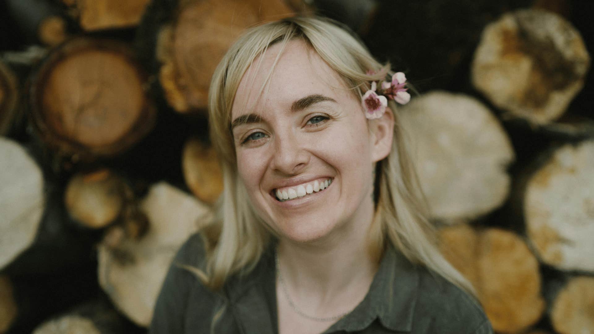 smiling woman with flower in hair