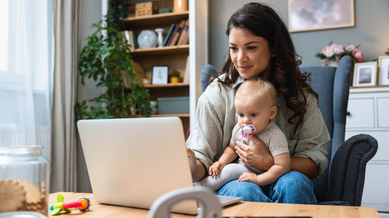 Wife Tells Husband She Needs Half Of His Company If He Wants Her To Be A Stay-At-Home Mom stay-at-home mom working on laptop with baby sitting on her lap