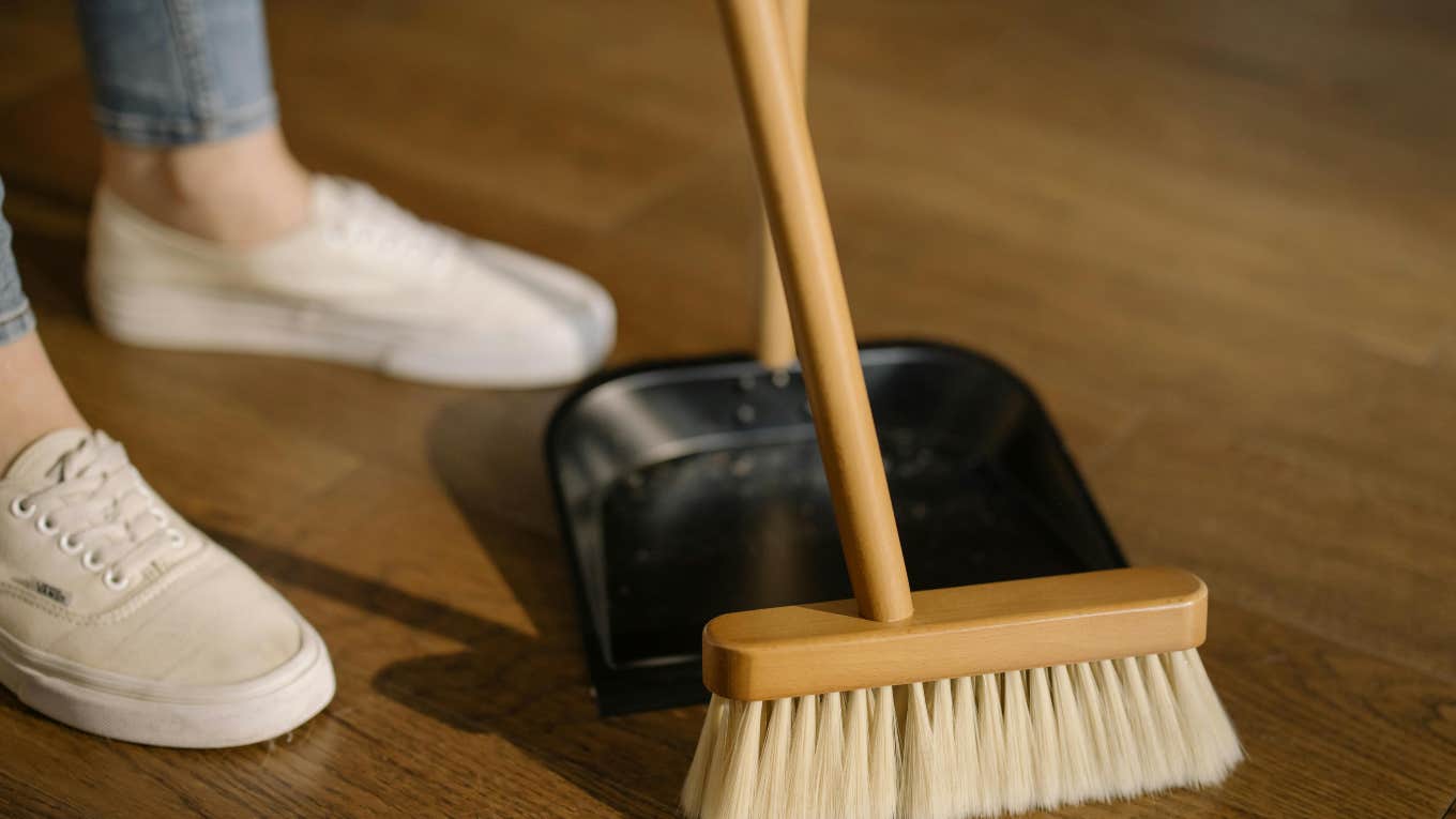 Woman Says Moms Should Not Post Their 'Filthy' Homes On Social Media person sweeping the floor with a broom