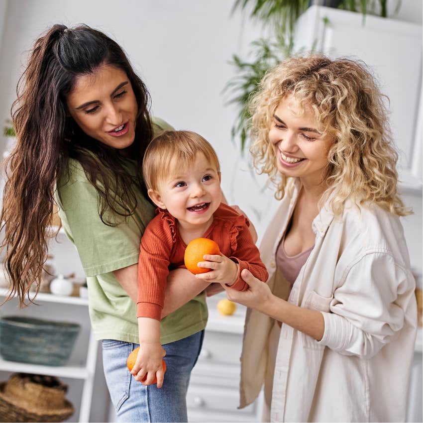 two moms with a baby