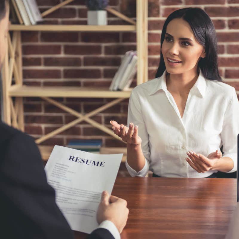 female employee in suit smiling during the job interview