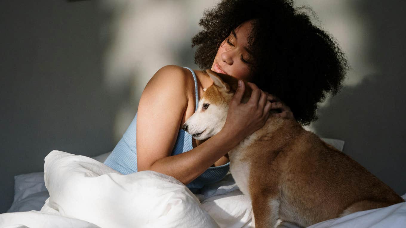 Sweet Benefits Of Letting Your Dog Sleep With You woman with dog in bed