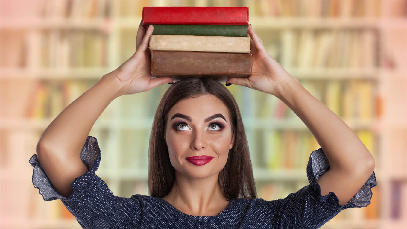 Areas Of Life The Smartest People Excel In Woman who is smart holds books above heads and knows she excels in certain areas of life.