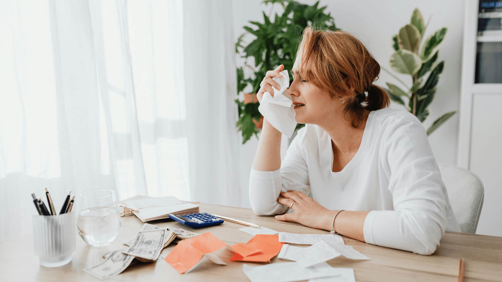 woman crying over bills