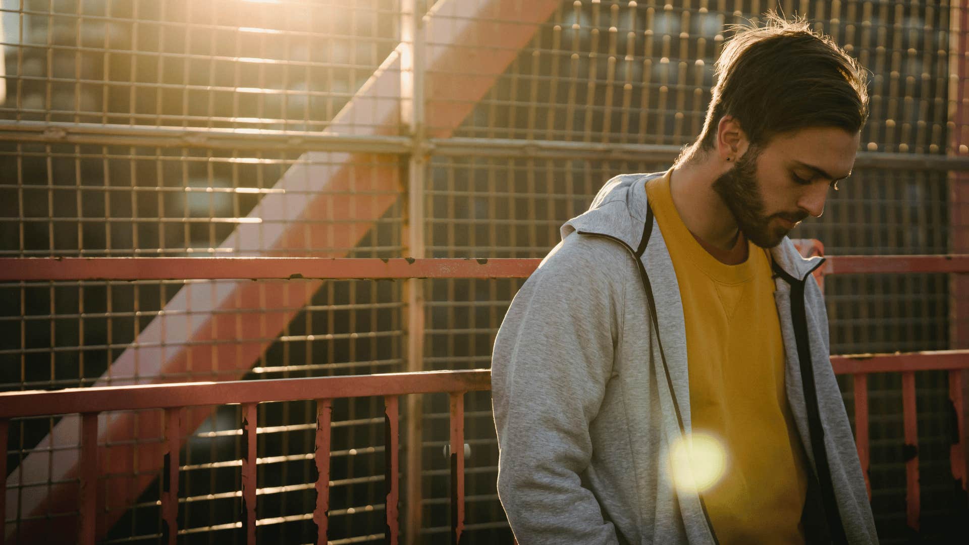 man thinking about his life on a bridge