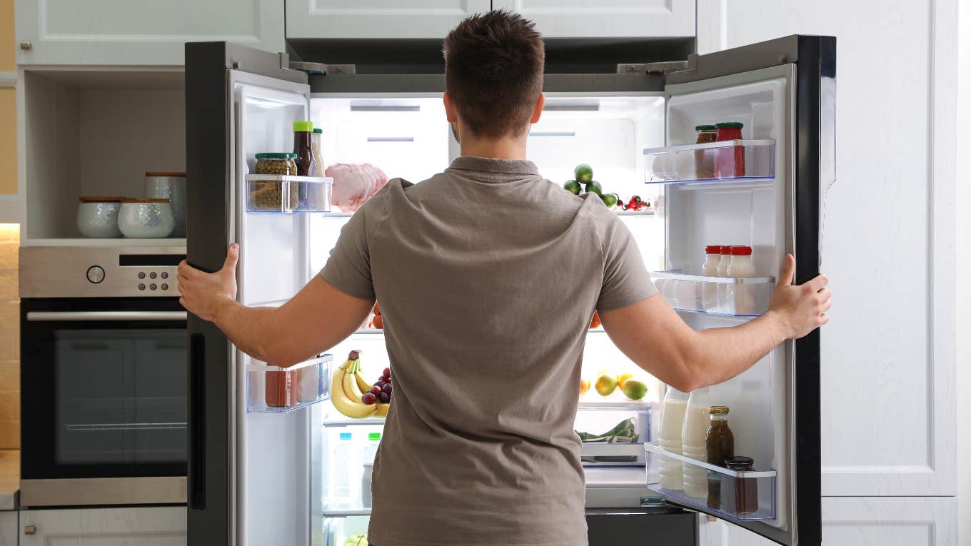 Dad Asks If It's His Job To Make Sure There Is Food In His Kid's Mom's Fridge Man looking in fridge