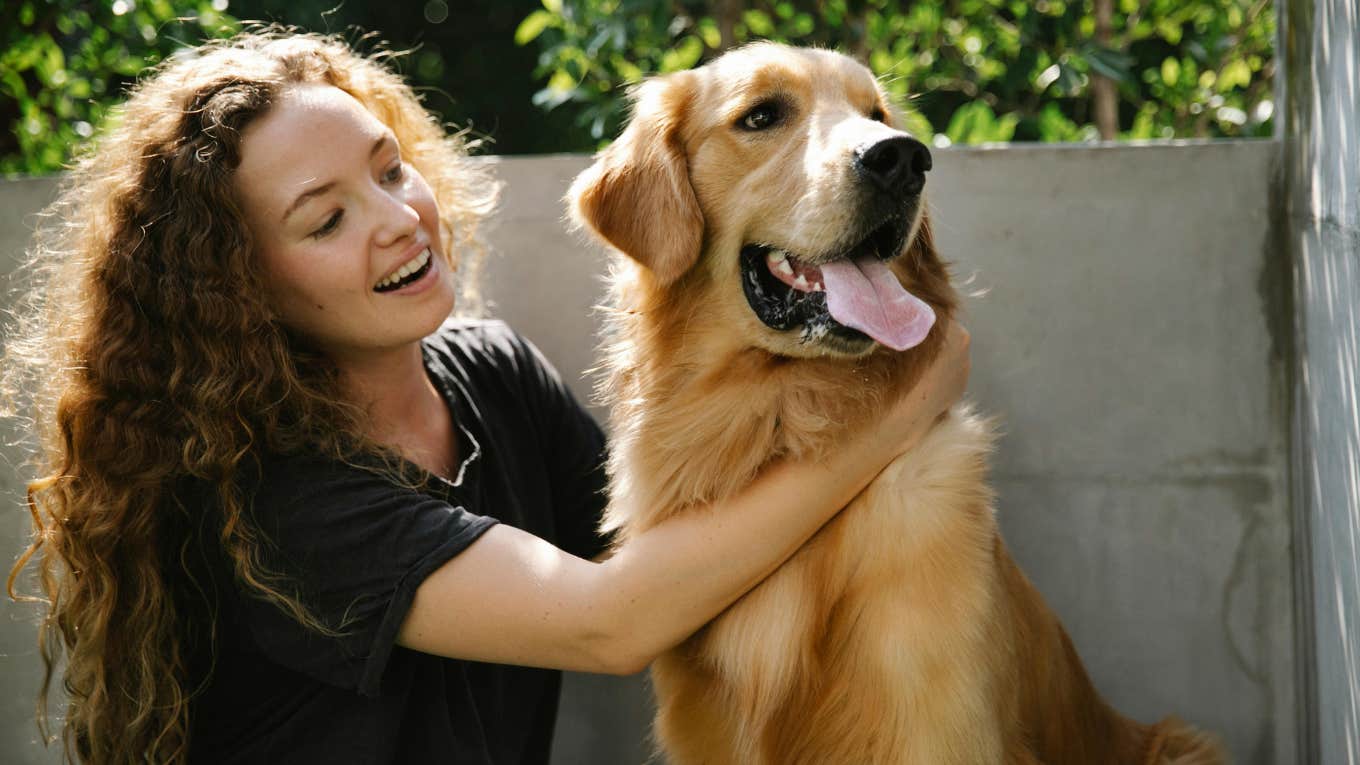 Dog Owner Leaves Her Anxious Rescue Dog With A Pet Sitter For The First Time In 10 Years — It Did Not Go Well woman petting a golden retriever