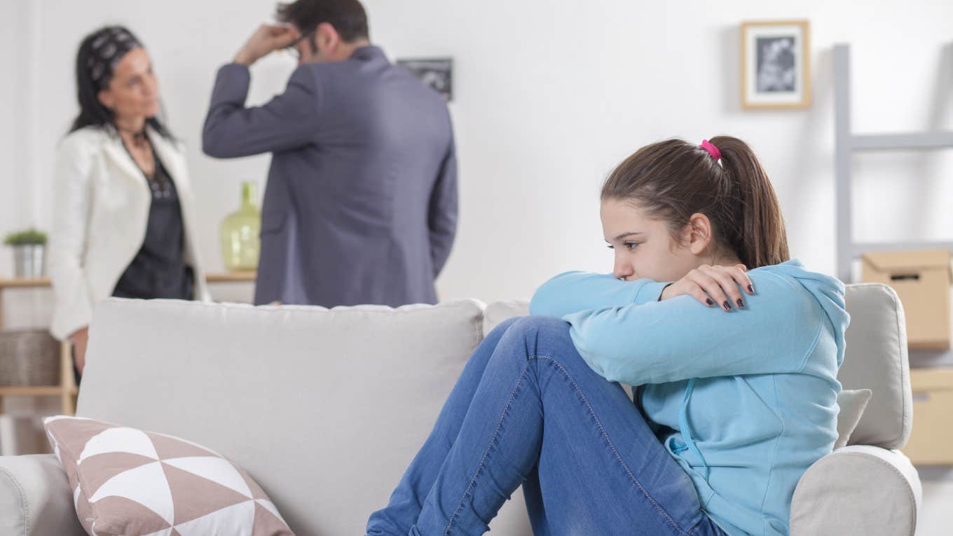 Father Says He Won't Pay For Daughter's College Tuition If She Takes Time Off To Grieve Her Friend upset teenage girl sitting on couch while parents argue behind her