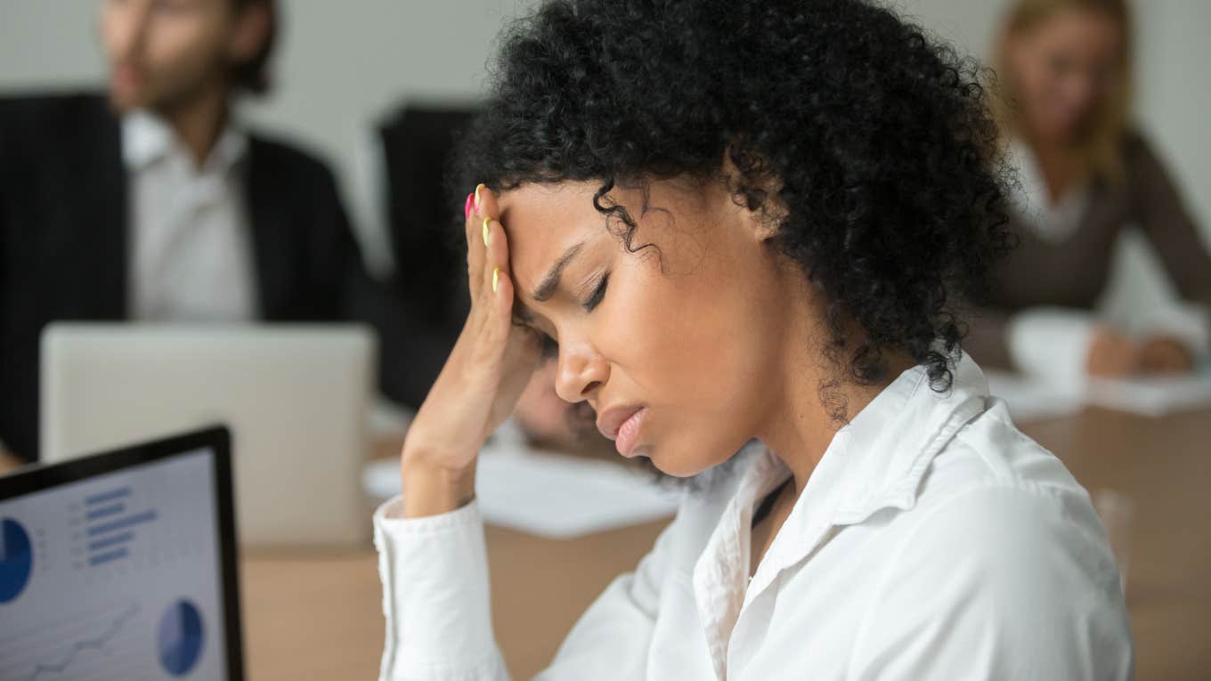 Fed Up Worker Says Going To Work Every Day Is Stupid businesswoman feeling unwell from headache touching forehead at team meeting