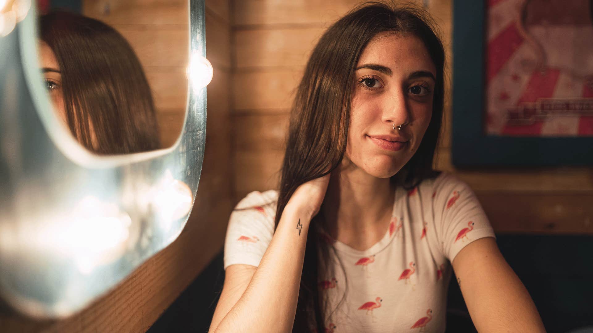 woman sitting at restaurant with mirror