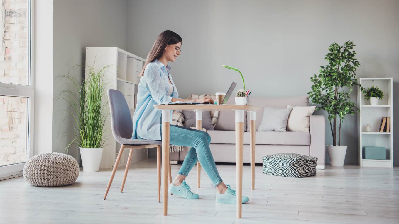 Gen-Z Worker Defends Her 'Non-Aesthetic' Job woman sitting at a desk in jeans