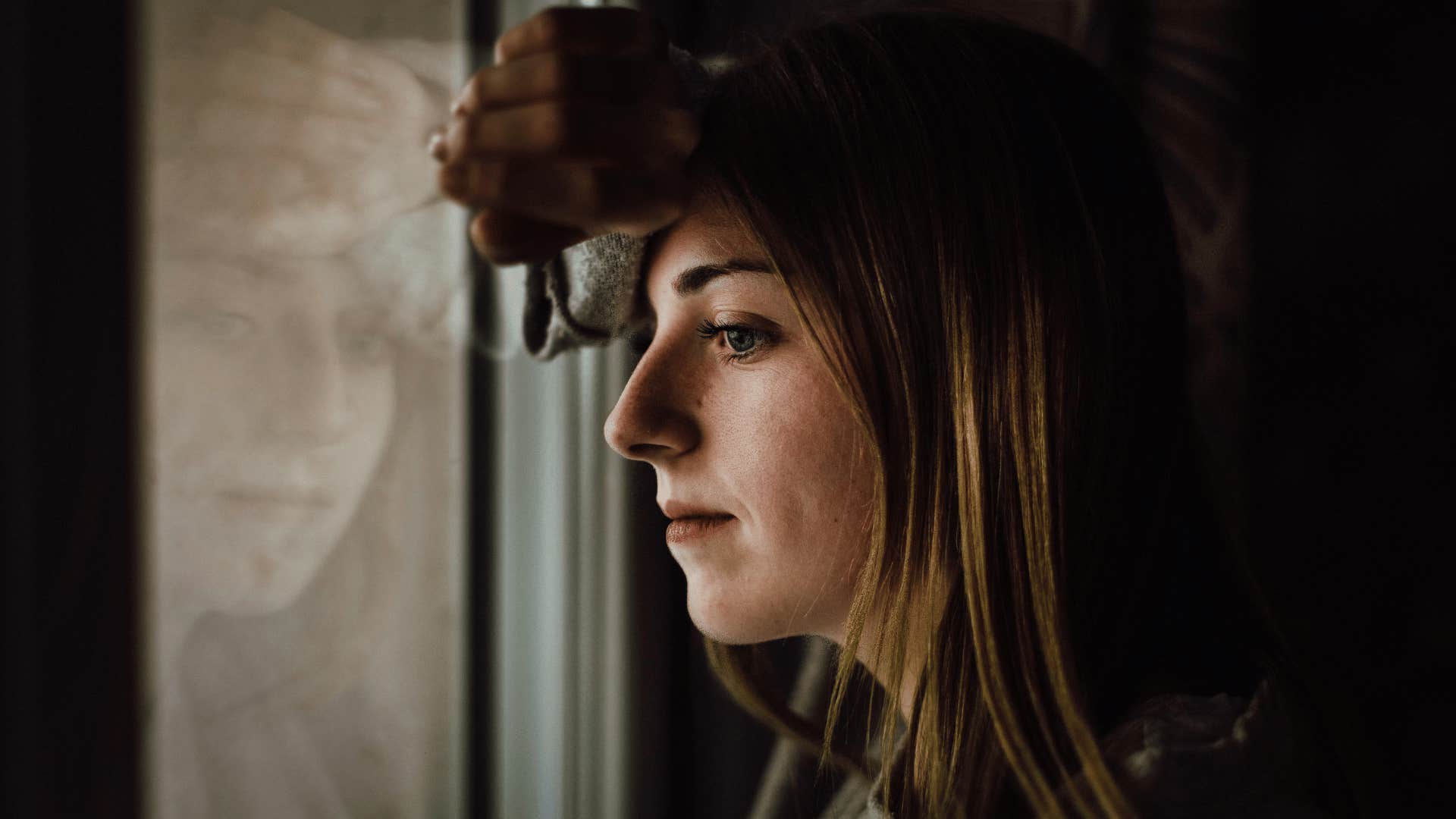 woman looking out the window