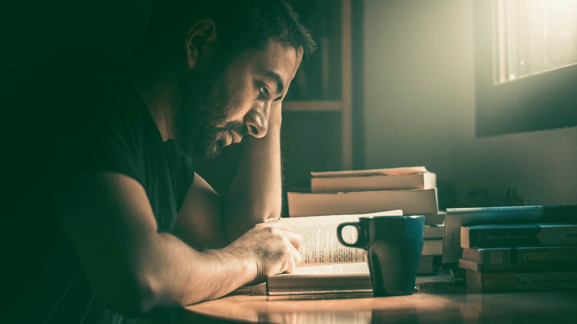 man reading at a desk