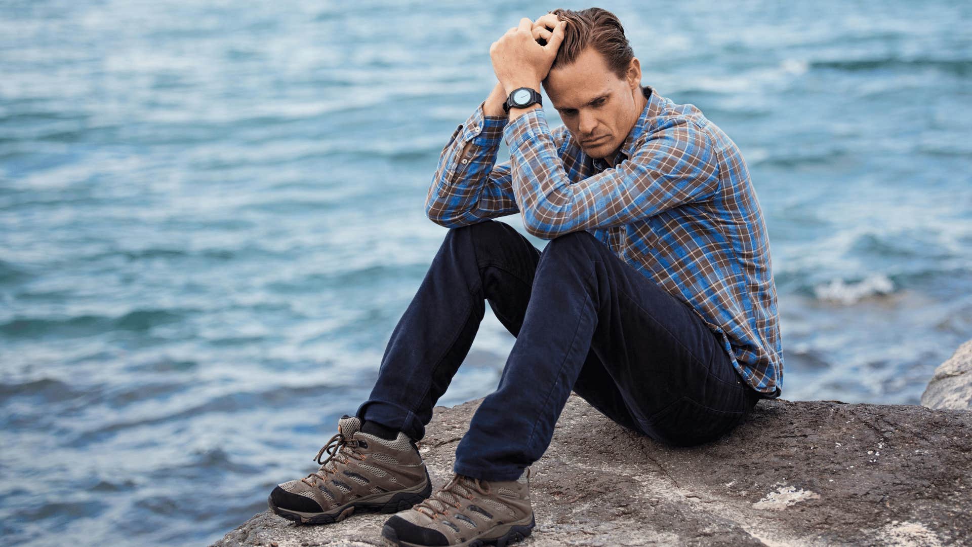 man reflecting by the water