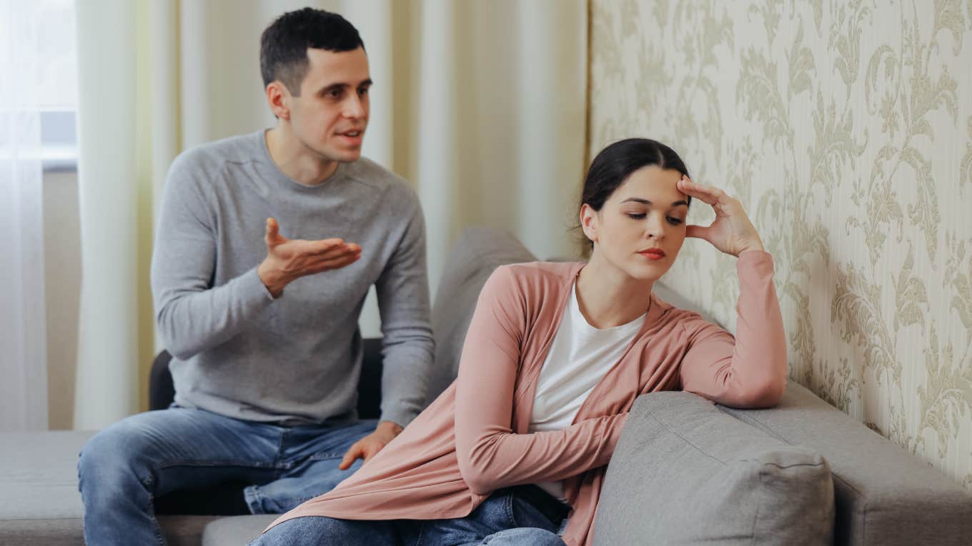 Mom Explains The Common Nag Paradox That Too Many Wives Face In Their Marriages husband arguing with annoyed wife whose back is to him while sitting on couch
