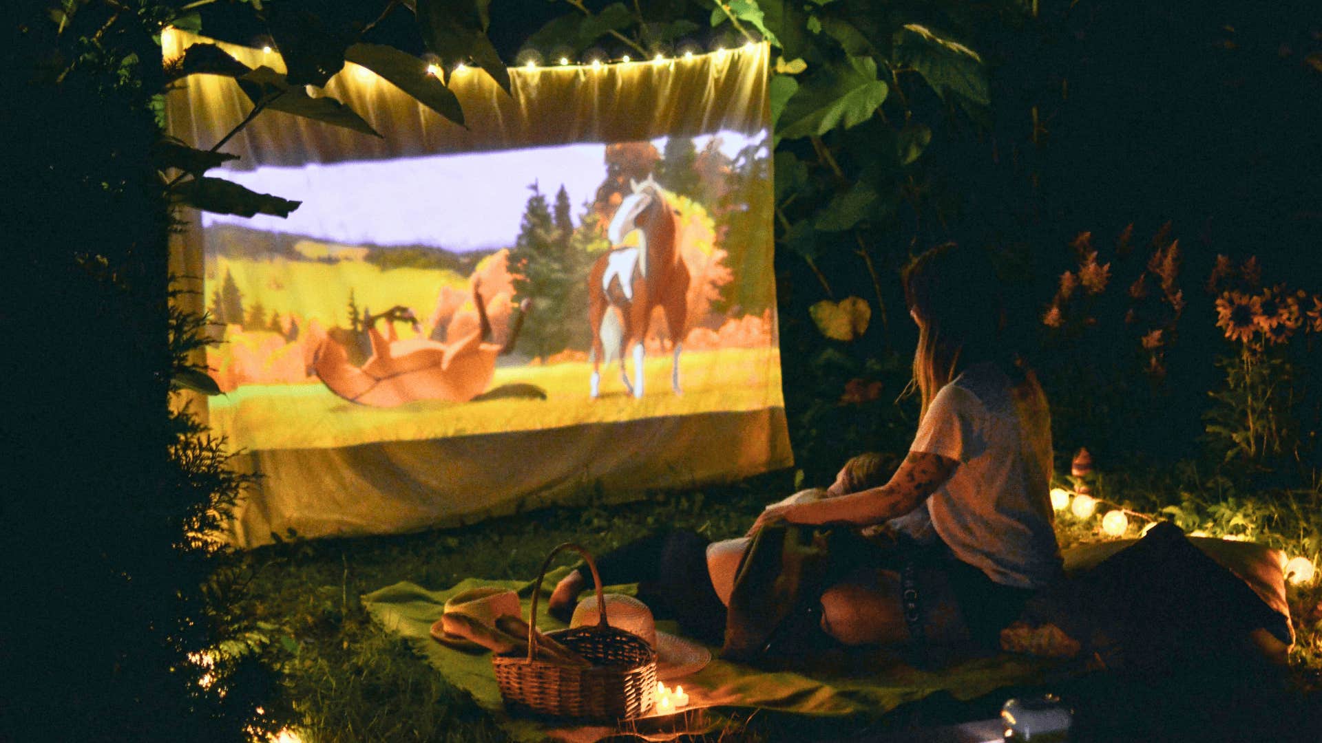 woman watching animated movie outside