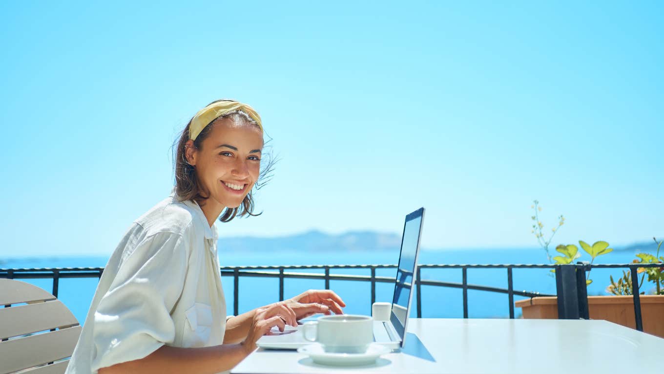 Nearly Half Of U.S. Workers Feel Guilty For Planning A Summer Vacation woman on laptop by the beach