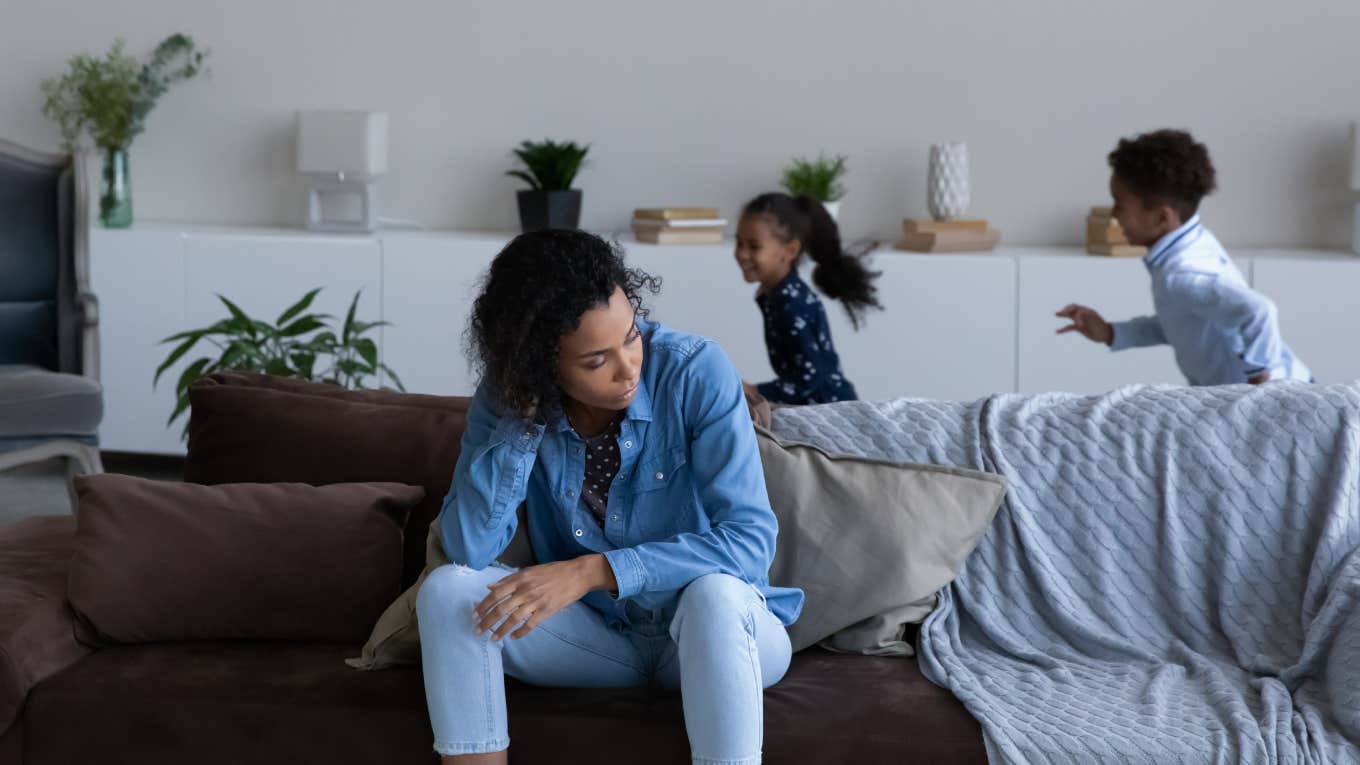 Overwhelmed Mom Voices Concern That The Village Is Collapsing mother feeling tired of noisy little children playing around her