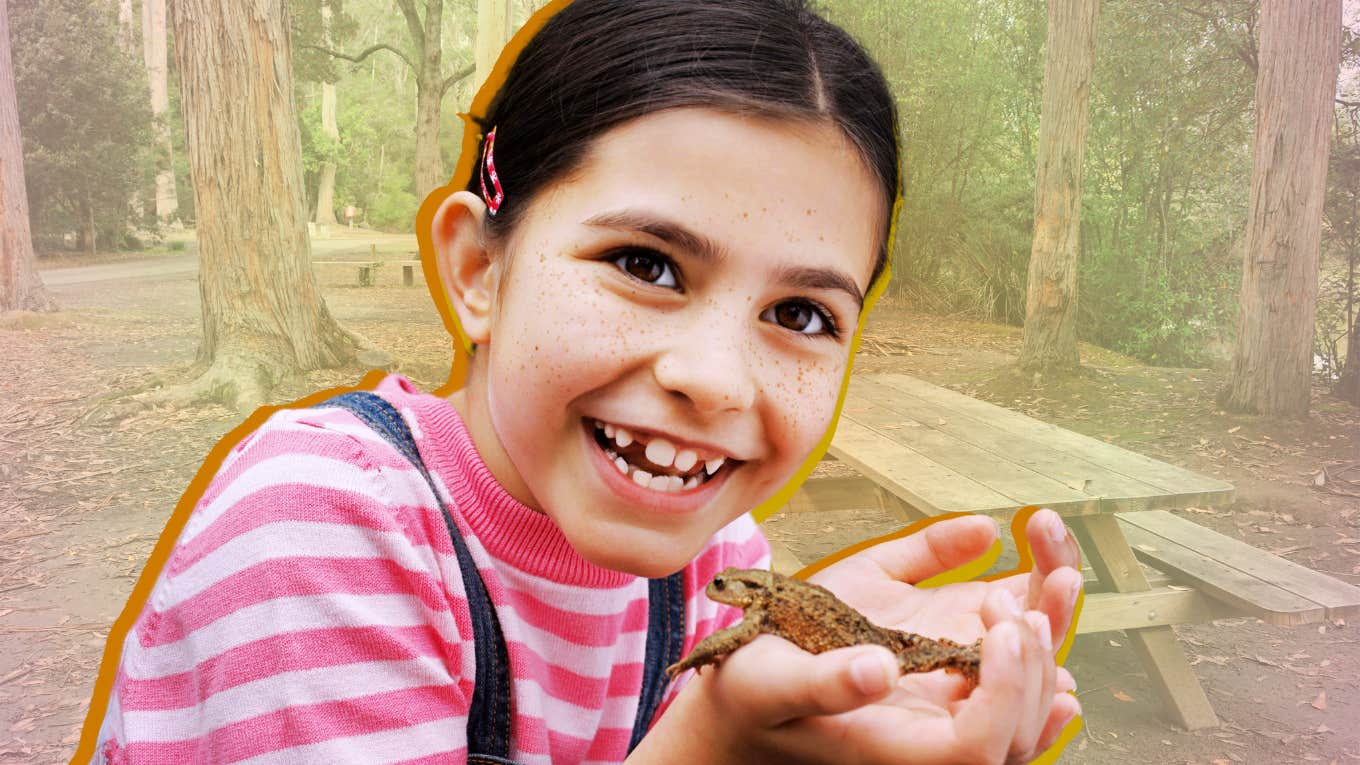 How To Help A Kid Feel Less Homesick — Without Coddling Them Young girl smiling holding a frog, reducing homesick anxiety at camp