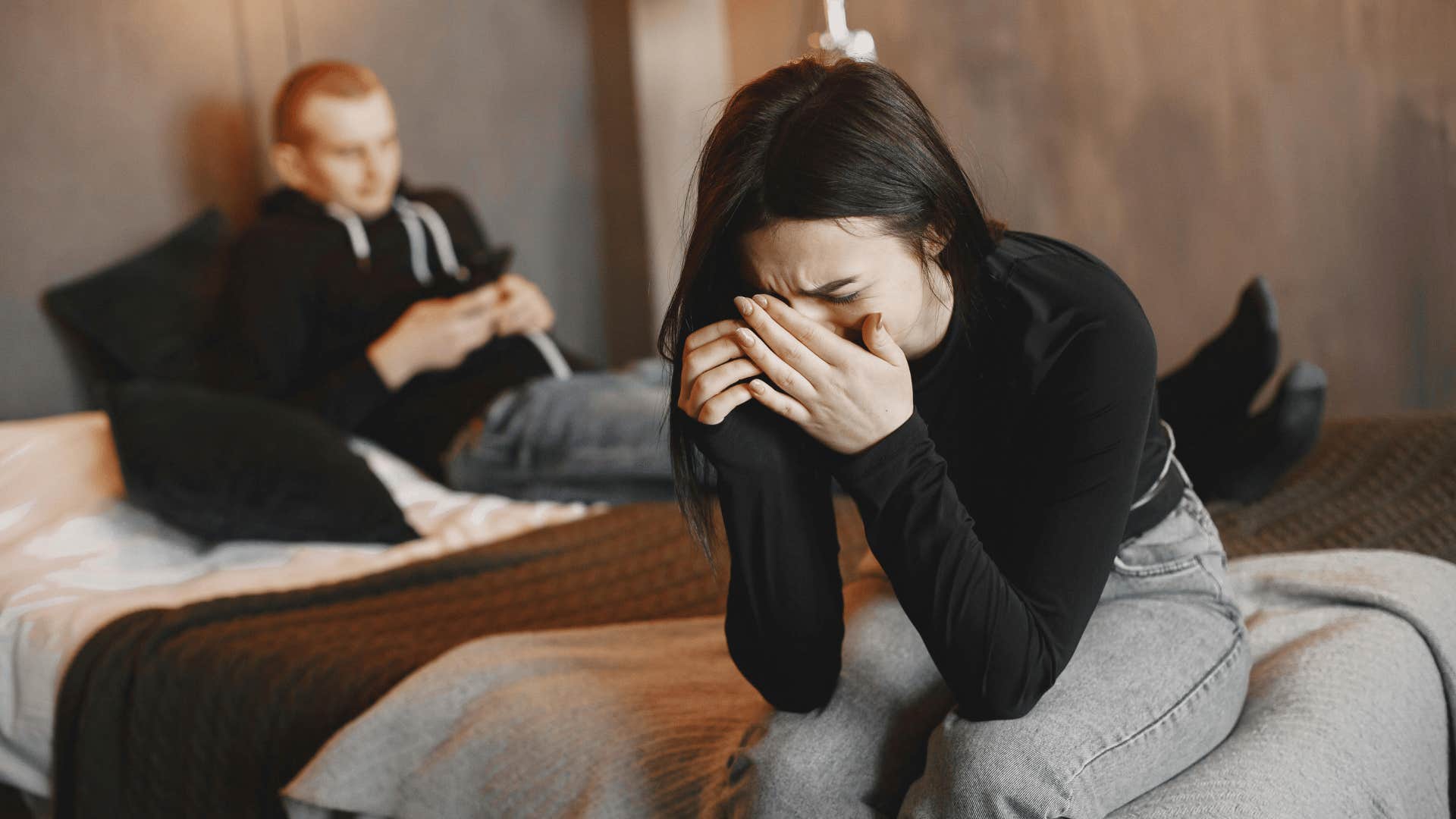 woman crying on man's bed