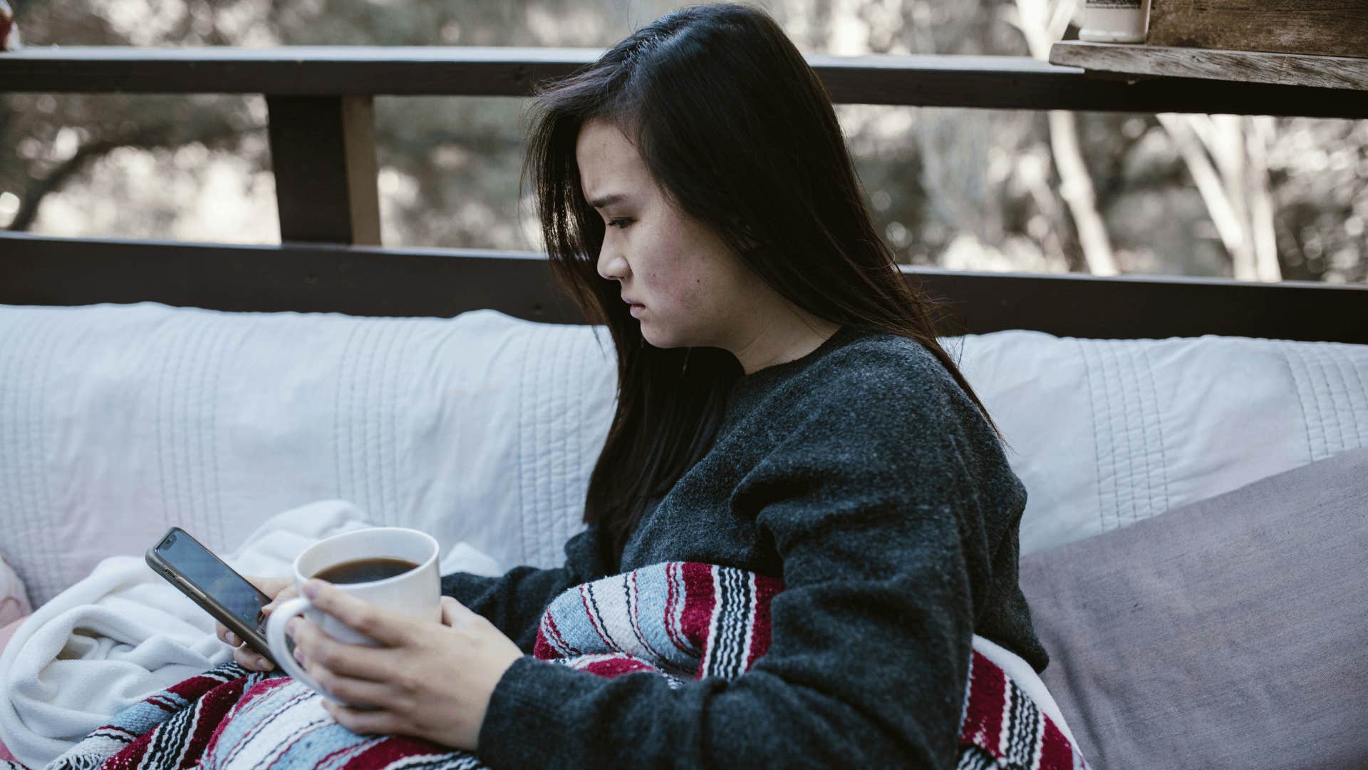 woman upset looking at phone
