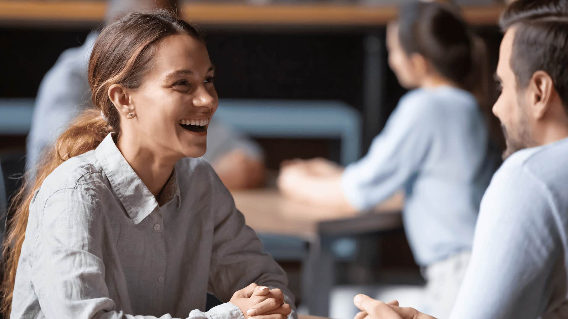 woman laughing at man's joke