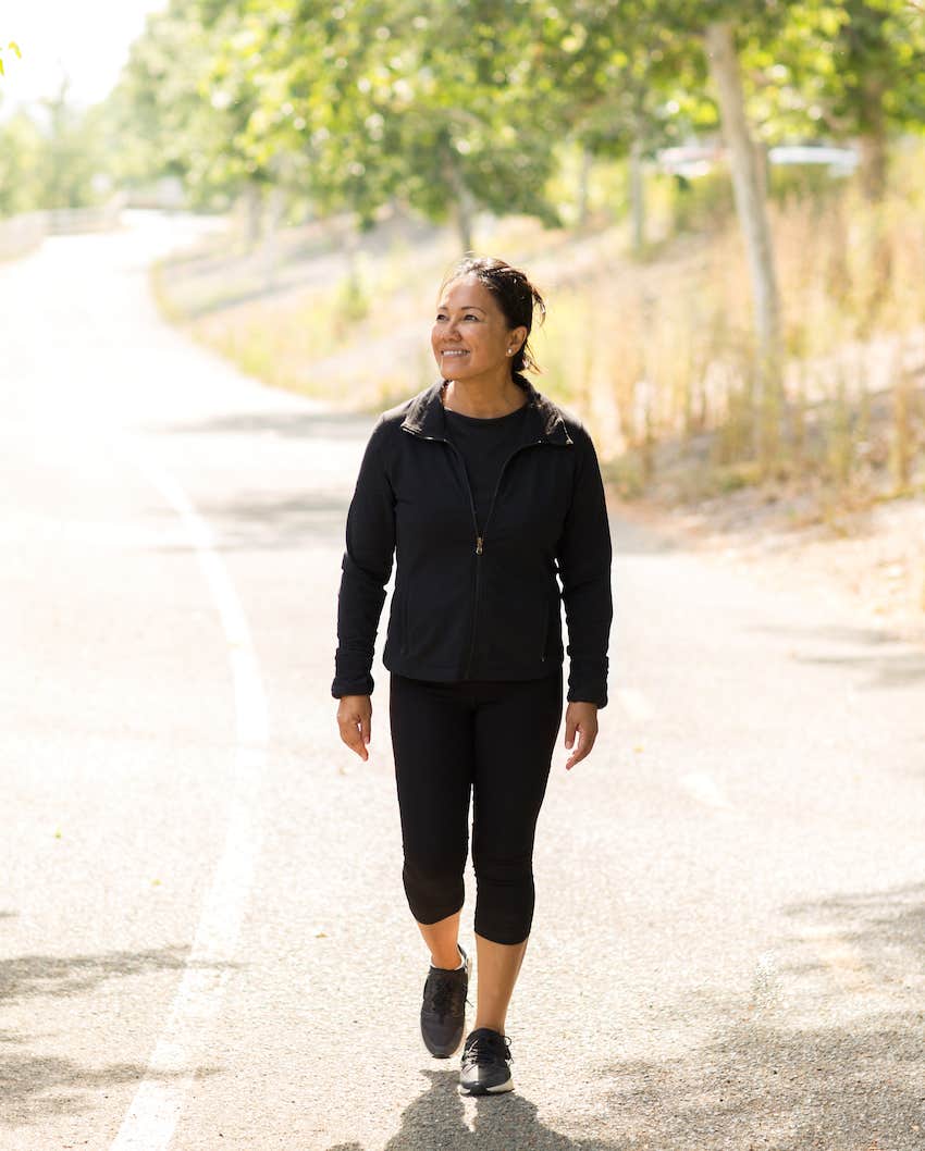 She walks alone on country road happy after divorce