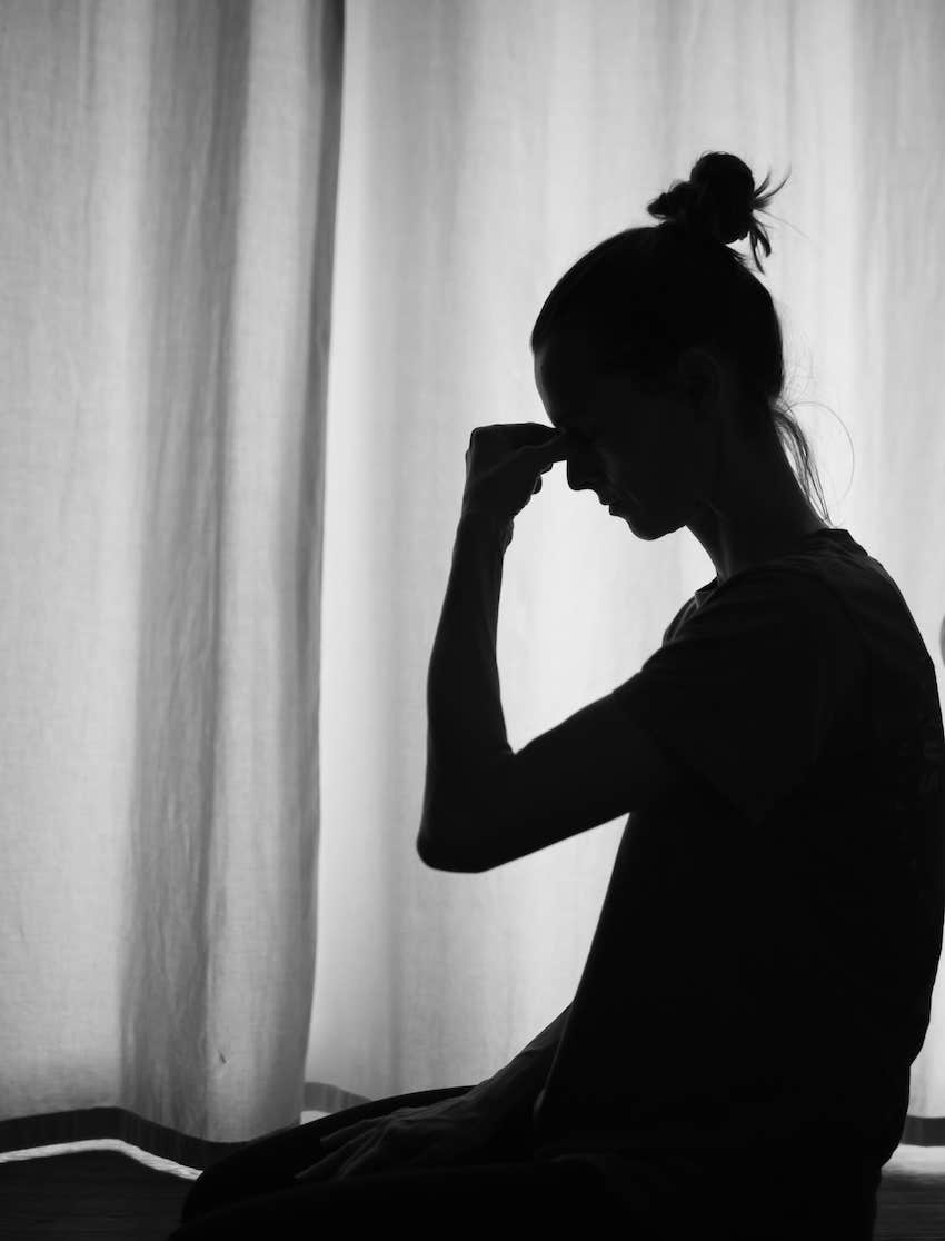 She releases tension touching her forehead to gain inner peace