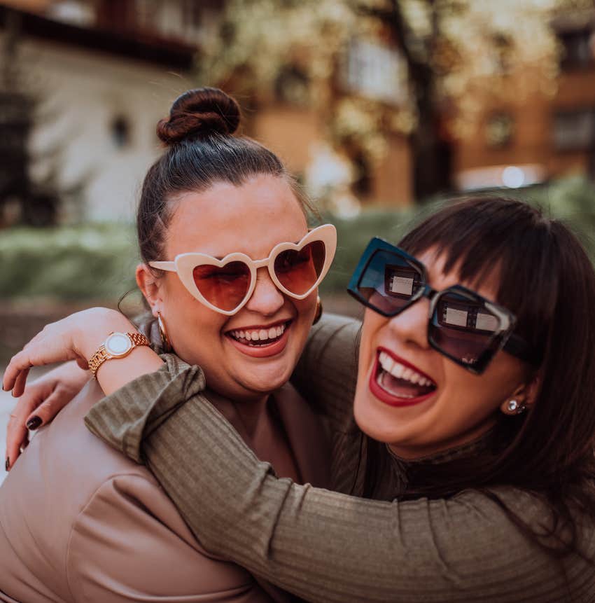 They hug happily with fun sunglasses on to create fireworks of love