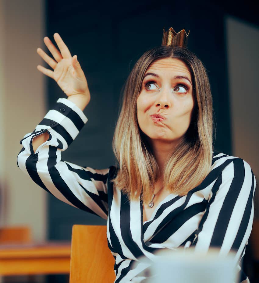 Selfish woman wears tiny crown and gestures from entitlement