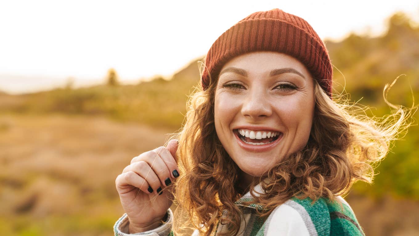 Signs Of A Low-Maintenance Woman low maintenance woman smiling outdoors