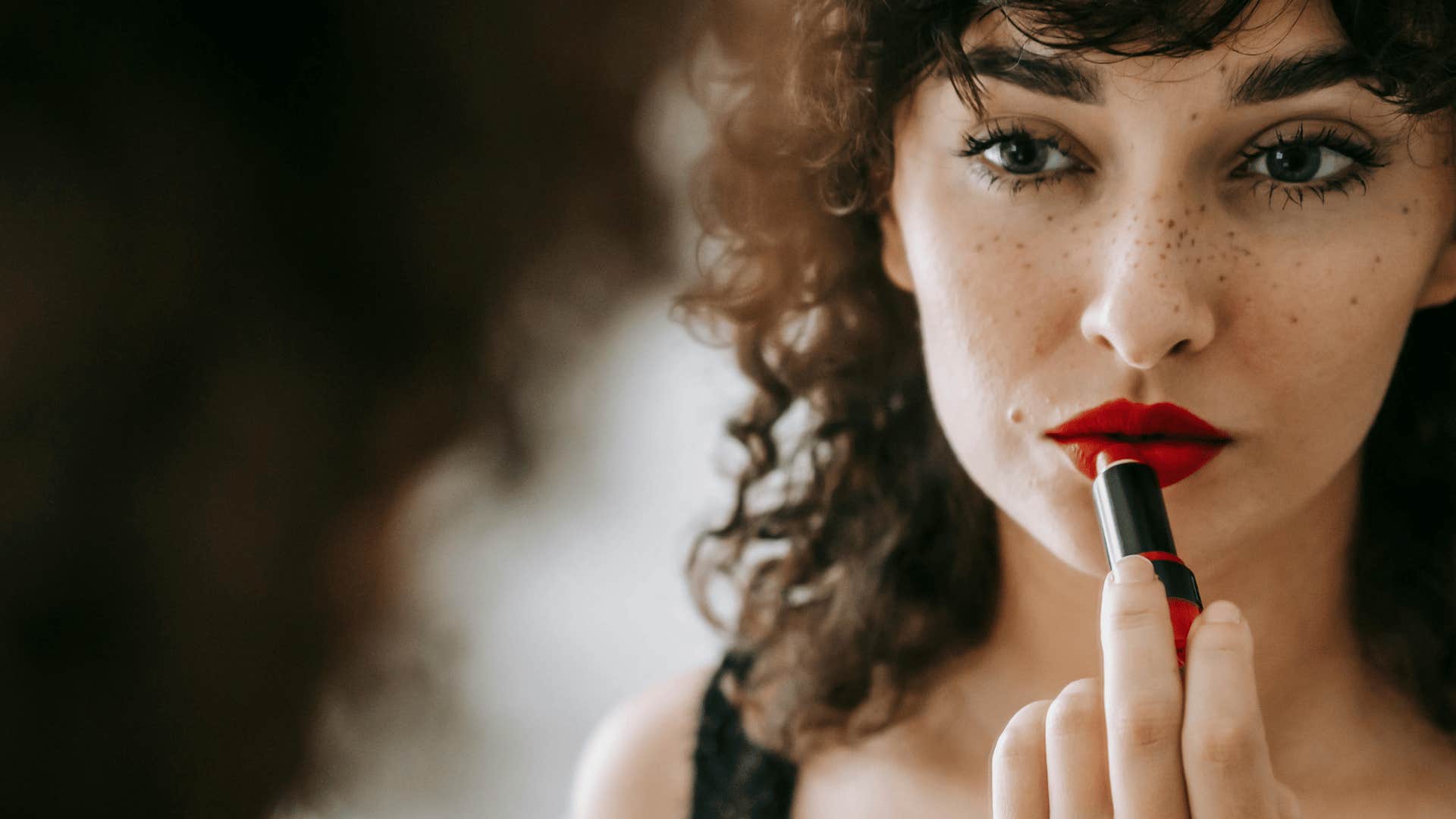 woman applying lipstick