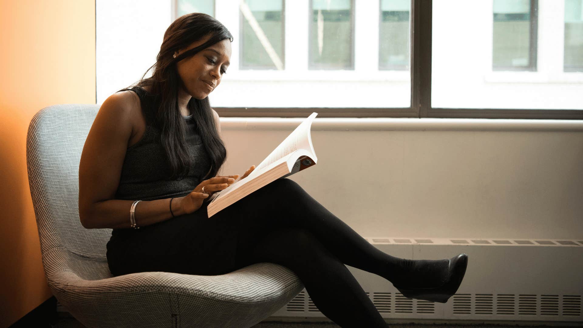 woman smiling and reading
