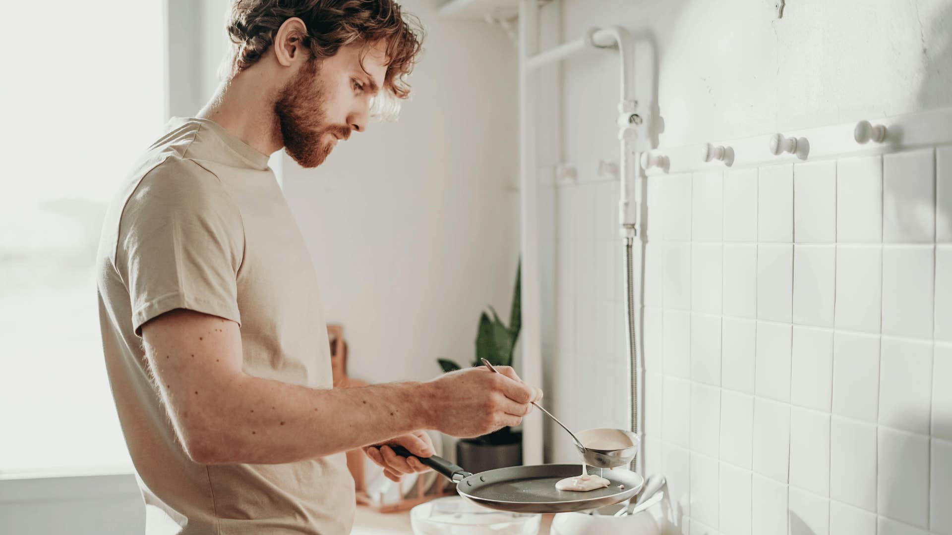 man cooking and eating well