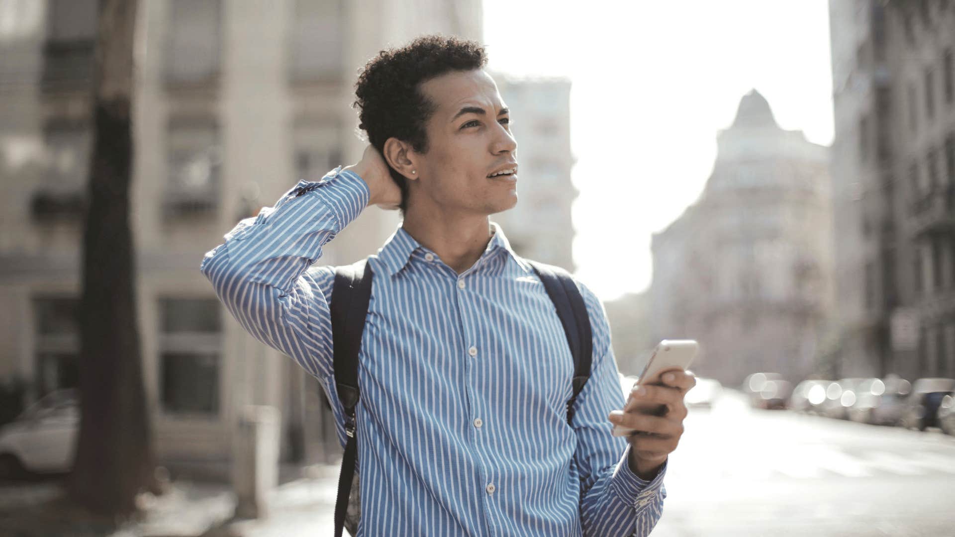 man looking up from phone