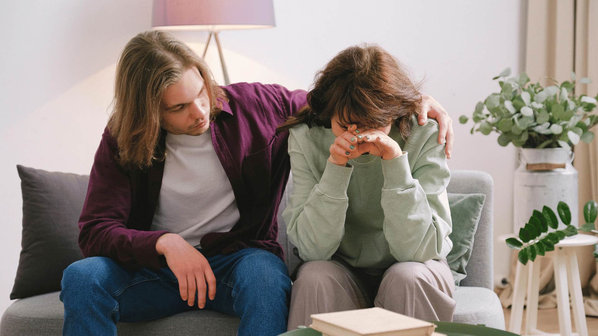 man comforting woman