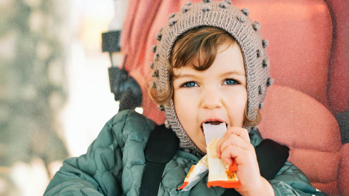 Ways To Feed Your Kids Healthier Snacks They'll Actually Eat, According To A Nutritionist Child eating a healthy snack