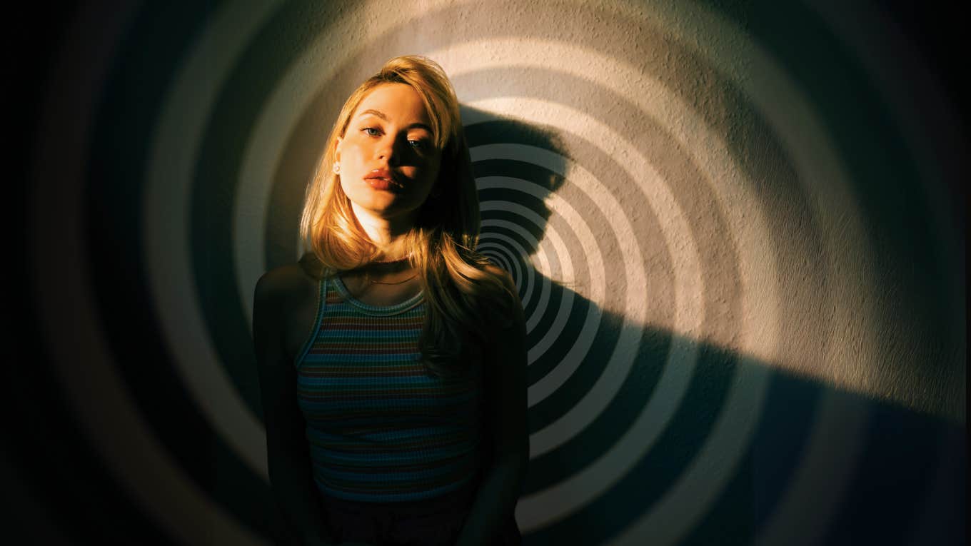 How I Learned To Stop Shame-Spiralling Woman leaning against wall feeling herself spiral into shame, Stopping feeling ashamed