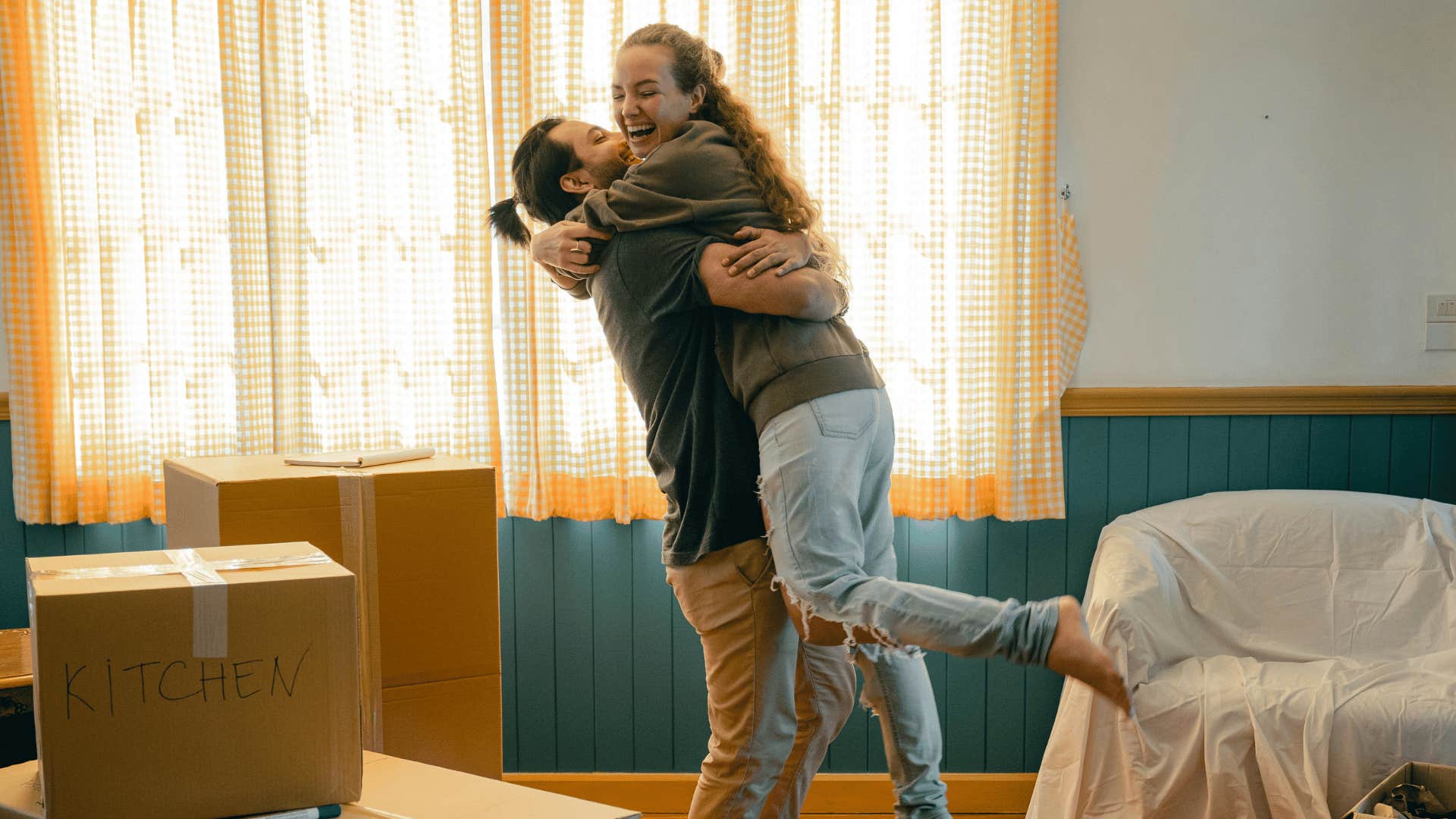 man lifting woman up in embrace