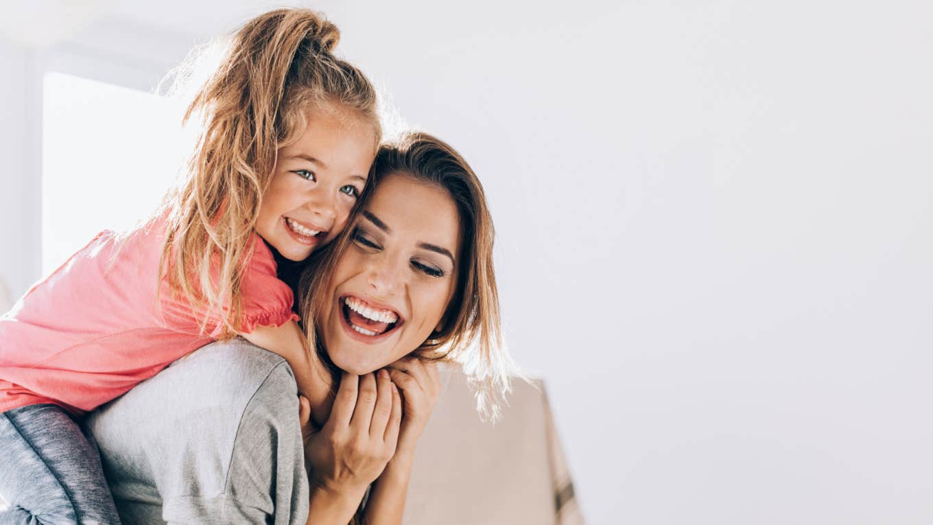Mom Shares 5 Things She’s Stopped Caring About To Improve Her Parenting Style mom and daughter laughing and connecting at home