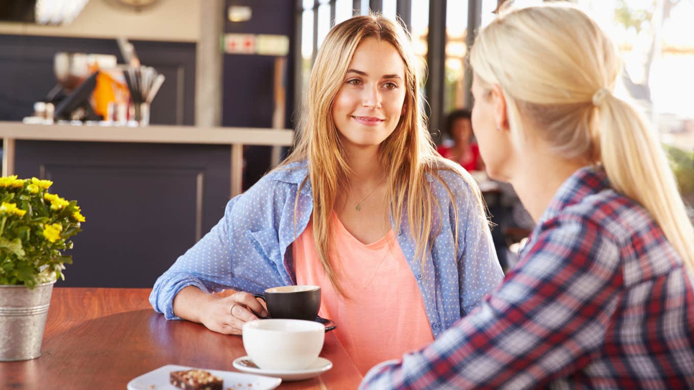 Psychology Coach Shares 2 Tricks To Make People Instantly Like You two blonde friends talking over coffee at cafe