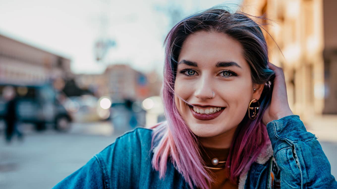 Subtle Behaviors Of People Who Carry Themselves With Dignity And Respect dignified and respectable woman with pink hair smiling