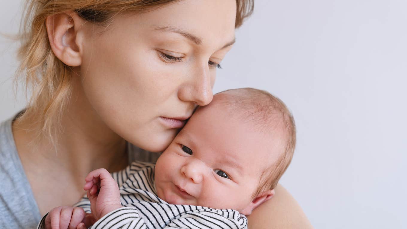 Dad Refuses To Buy His Wife's Push Present After She Loses Her Job Sad mom snuggling infant daughter