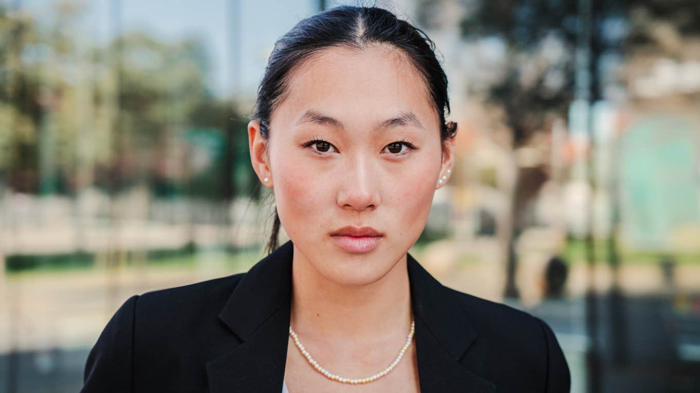 Honest Mistakes That Can Get You Fired From Your Job serious employee pondering her workplace choices