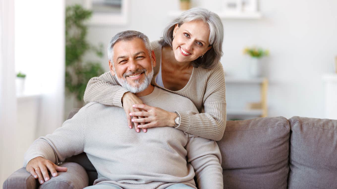 Married Women Answer If Living With Men Is Worth It And Give Some Surprising Responses close up of smiling wife with arms around husband sitting on couch