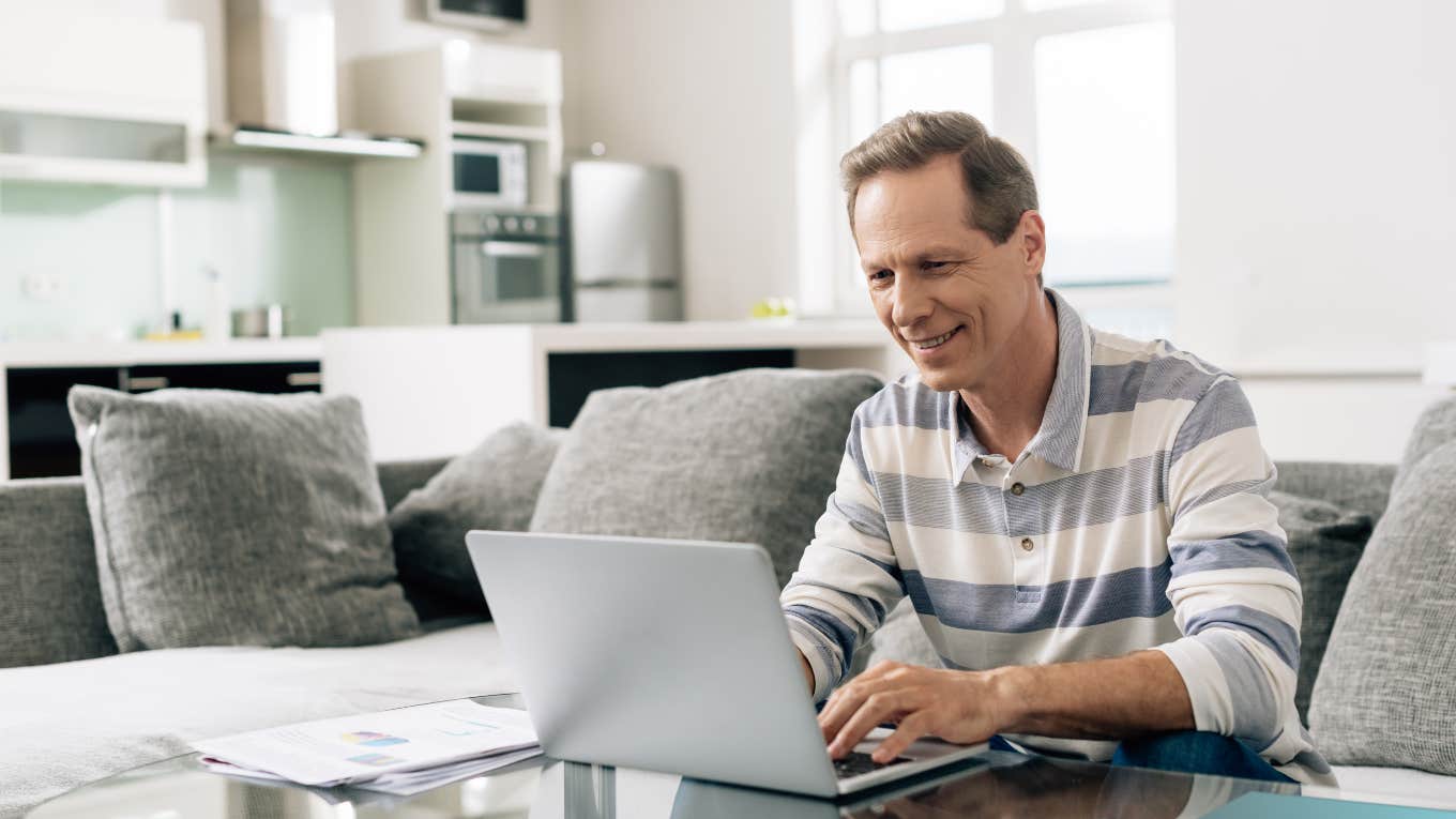 Mechanic Quits His Job With Ford To Pursue His Side Hustle man sitting on his couch at home using his laptop