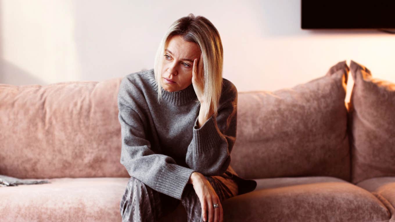 8 Reasons Your Marriage Is Unfulfilling That Have Nothing To Do With Your Partner Stoic woman who feels her marriage is unfulfilling