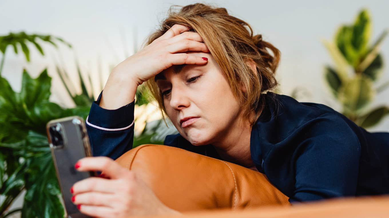 Sneaky Reasons You're Unhappy And Stressed Out, According To Clinical Psychologist Woman is unhappy and stressed out.